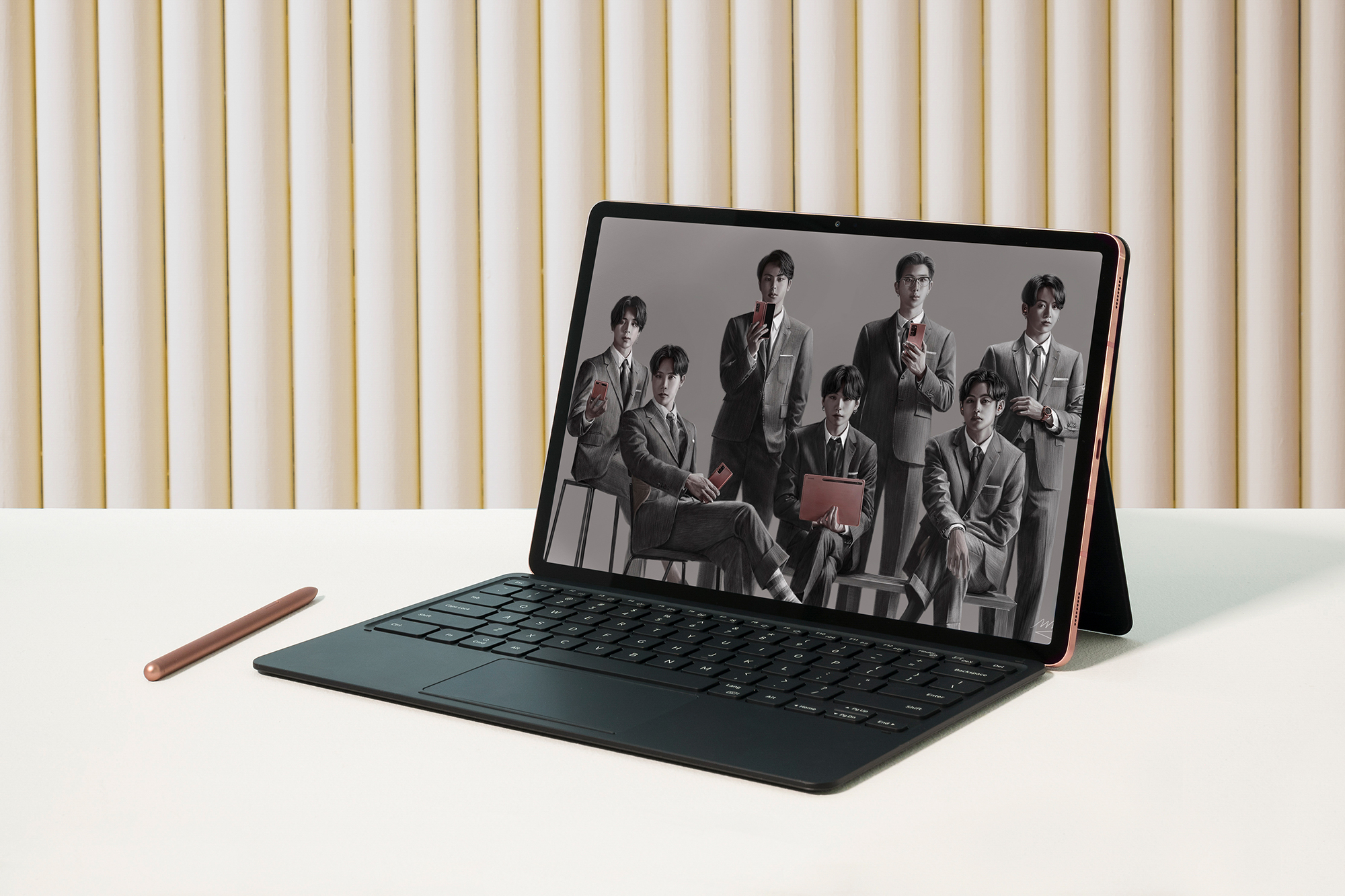 A Galaxy Tab S7+ with Book Cover Keyboard attached and S Pen beside it shows a digitally-drawn image of BTS with the latest Galaxy products.