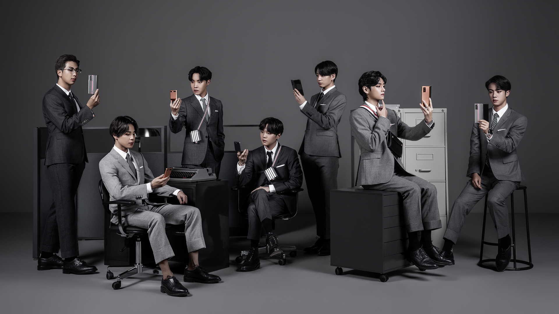 BTS joins the Thom Browne family in grey suits as they admire the Galaxy Z Fold2 Thom Browne Edition. Wide