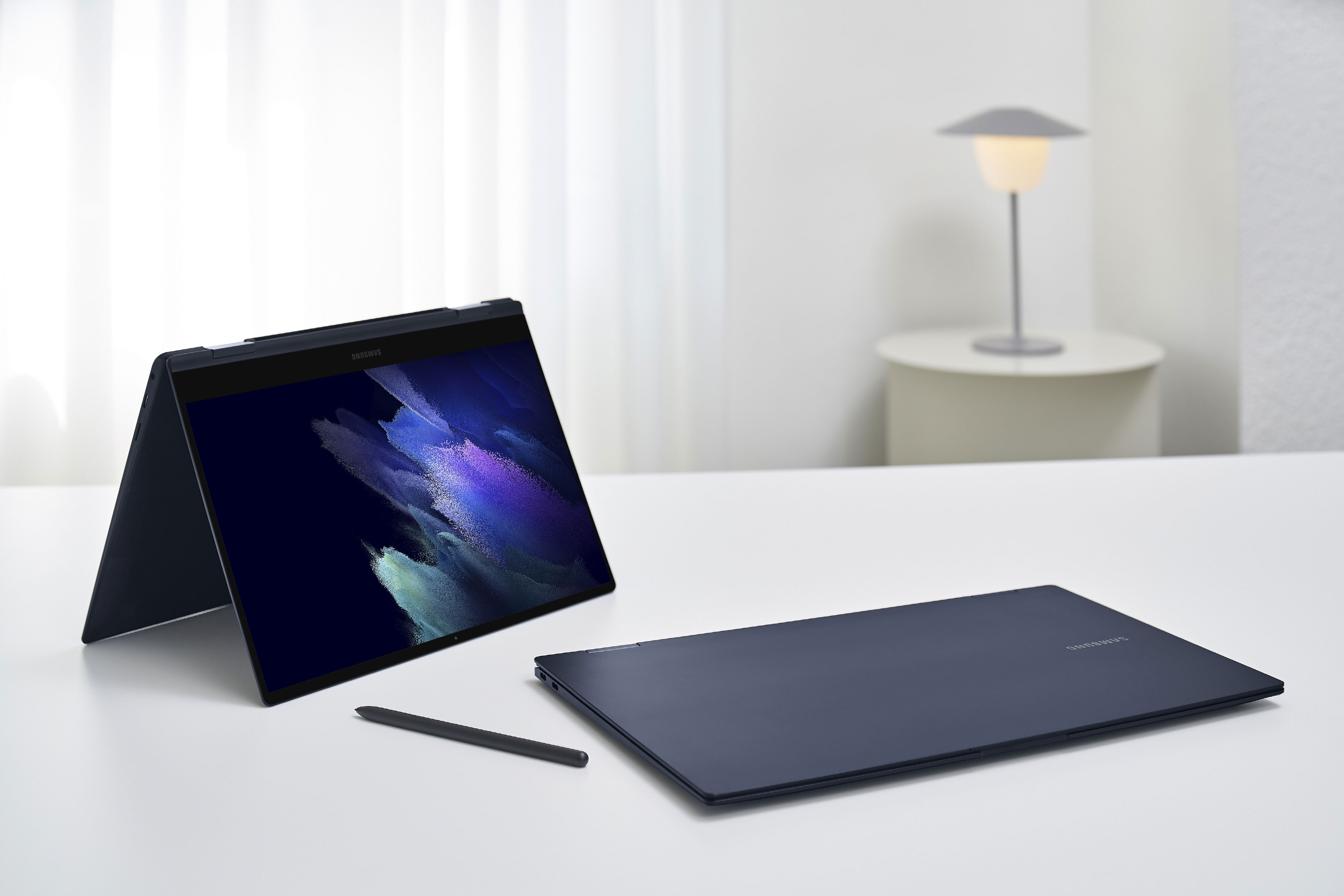 Galaxy Book Pro 360 13 inch in mystic navy and 15 inch in mystic navy on white desk with S Pen