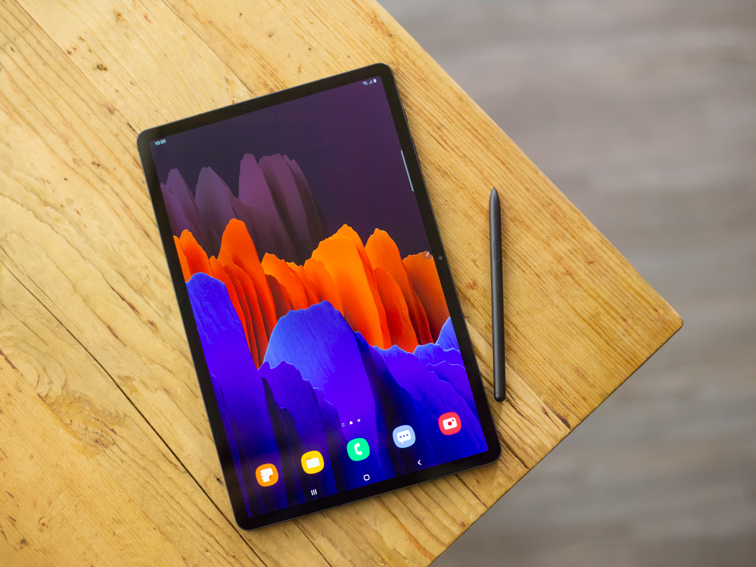 Galaxy Tab S7 Plus in Mystic Black with S Pen on a brown surface